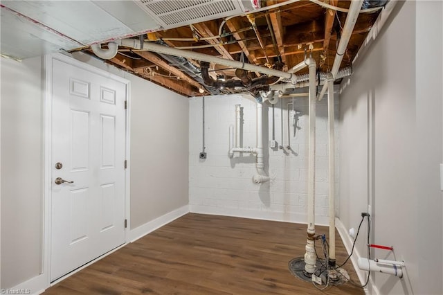 basement featuring dark hardwood / wood-style flooring