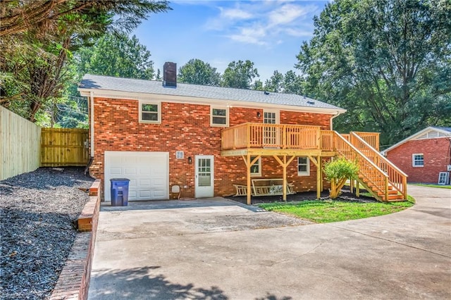 view of front facade featuring a wooden deck and a garage