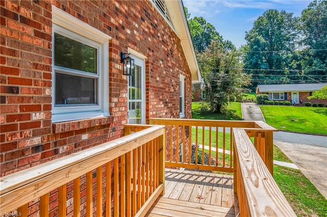 wooden terrace with a yard