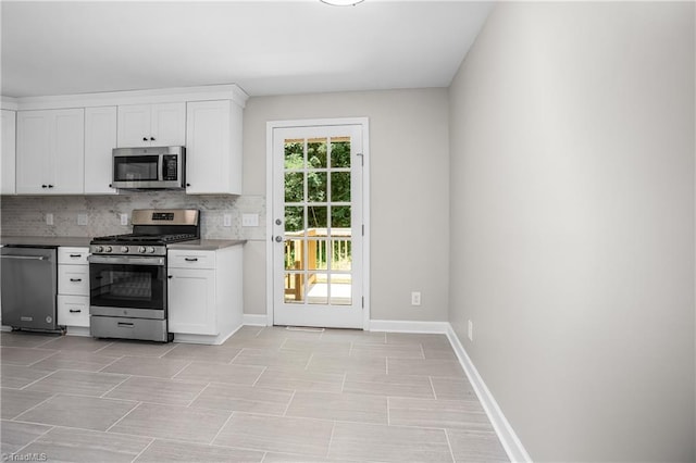 kitchen featuring tasteful backsplash, a wealth of natural light, stainless steel appliances, and white cabinets