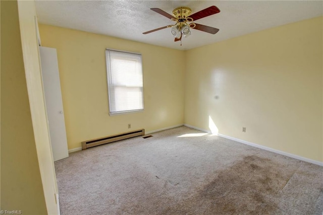 spare room with ceiling fan, light colored carpet, a textured ceiling, and a baseboard heating unit