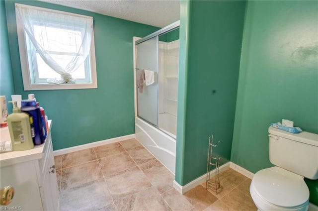 full bathroom featuring bath / shower combo with glass door, toilet, tile patterned flooring, and a textured ceiling