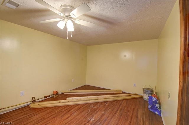 unfurnished room with wood-type flooring, a textured ceiling, and ceiling fan