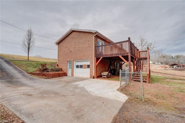 view of side of home with a garage and a deck