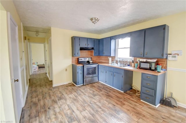 kitchen with blue cabinetry, stainless steel range with electric stovetop, sink, and light wood-type flooring