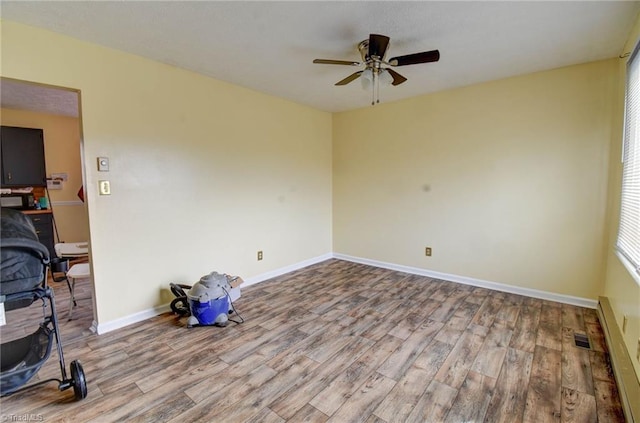 empty room featuring ceiling fan and wood-type flooring