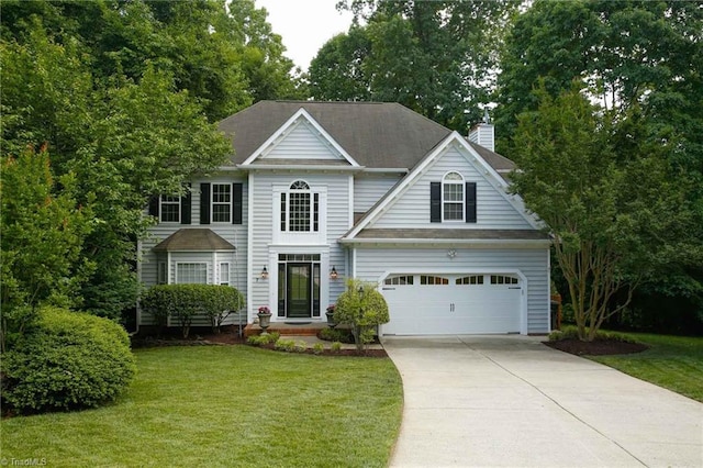 view of front of property with a chimney, driveway, a front lawn, and a shingled roof