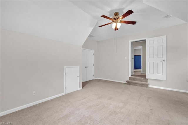 bonus room with a ceiling fan, carpet floors, baseboards, and lofted ceiling