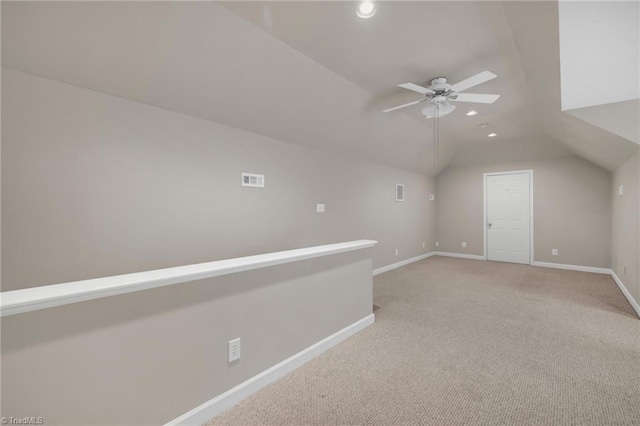 bonus room featuring recessed lighting, a ceiling fan, baseboards, lofted ceiling, and light carpet