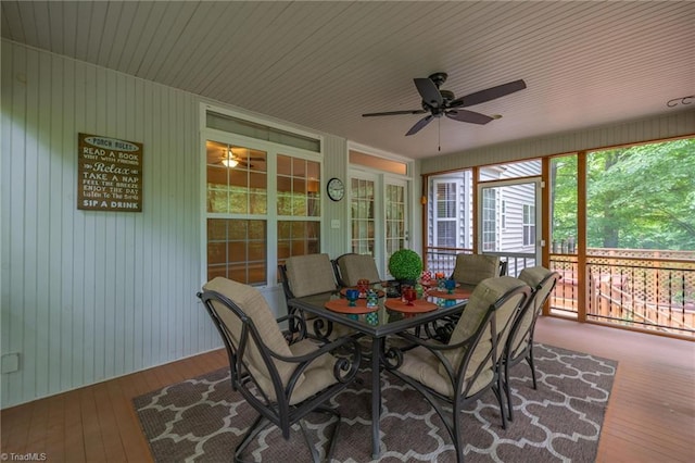 sunroom with ceiling fan and outdoor dining space