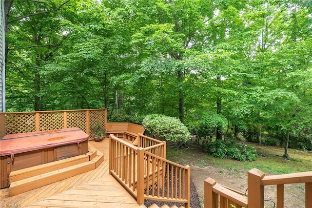 wooden terrace featuring a hot tub