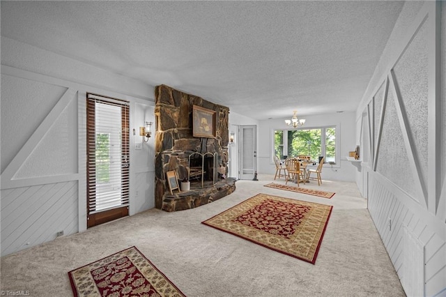1902 Meadow Lake Ln, Sophia, NC 27350 - living area featuring a textured ceiling, carpet floors, a chandelier, and a fireplace