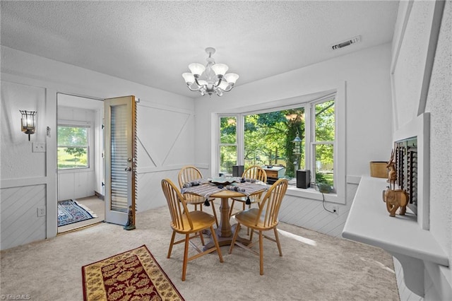 1902 Meadow Lake Ln, Sophia, NC 27350 - dining room featuring a chandelier, a textured ceiling, and carpet