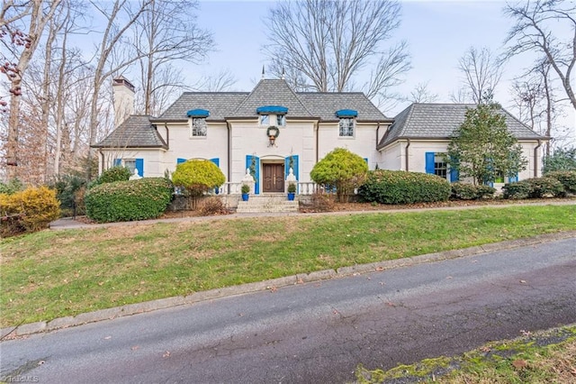 french country home with a front yard