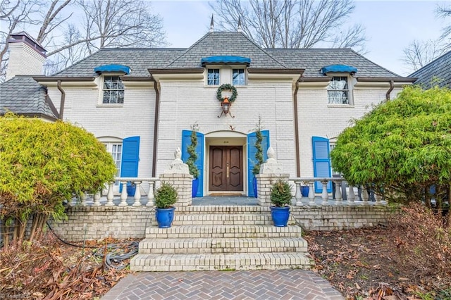 french country home featuring covered porch