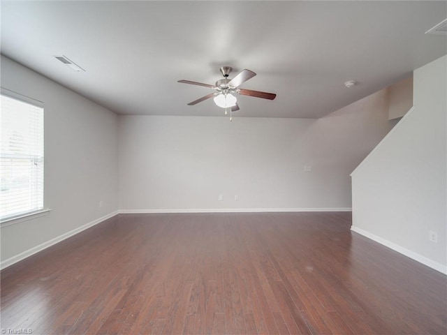 spare room featuring dark hardwood / wood-style floors and ceiling fan