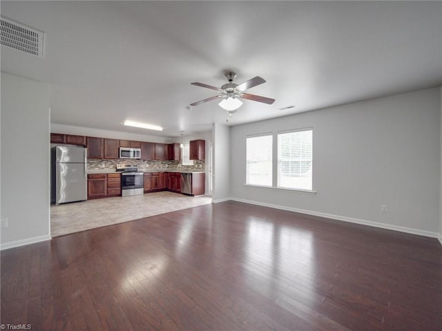 unfurnished living room with hardwood / wood-style floors and ceiling fan