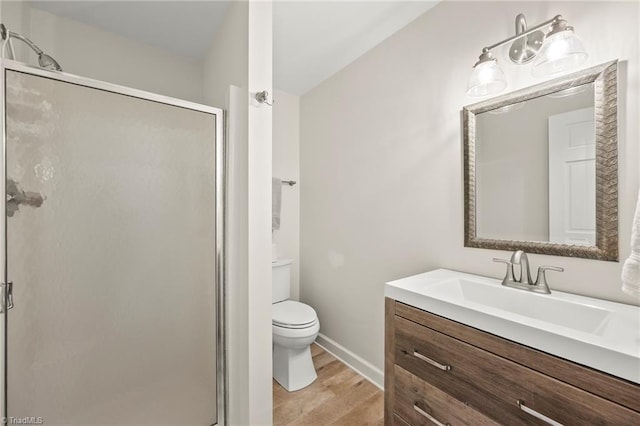 5017 Timbrook Ln, Winston-Salem, NC 27103 - bathroom with vanity, wood finished floors, a shower stall, and toilet