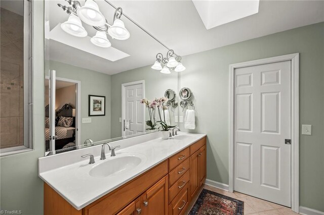 5017 Timbrook Ln, Winston-Salem, NC 27103 - ensuite bathroom with a skylight, double vanity, baseboards, and tile patterned floors