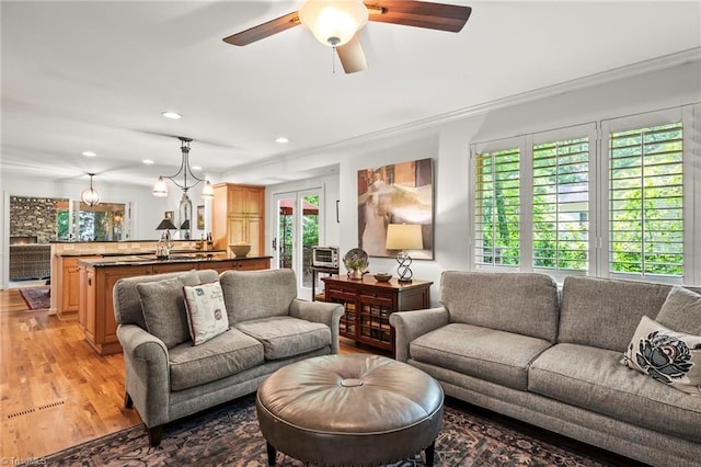 5017 Timbrook Ln, Winston-Salem, NC 27103 - living room featuring light wood finished floors, recessed lighting, crown molding, and a ceiling fan