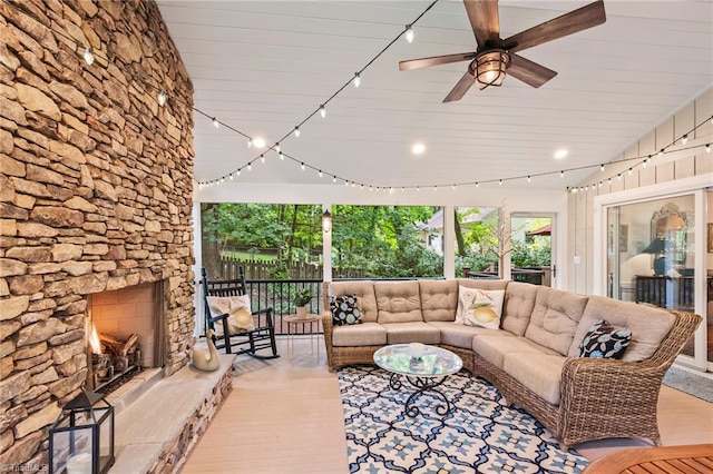 5017 Timbrook Ln, Winston-Salem, NC 27103 - living room featuring a ceiling fan, light wood finished floors, and a stone fireplace