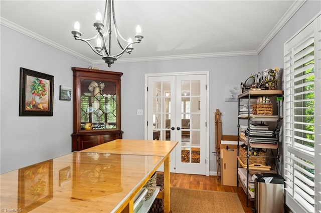 5017 Timbrook Ln, Winston-Salem, NC 27103 - dining space featuring french doors, a chandelier, wood finished floors, and crown molding