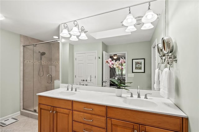 5017 Timbrook Ln, Winston-Salem, NC 27103 - full bath featuring double vanity, a shower stall, tile patterned flooring, and a skylight