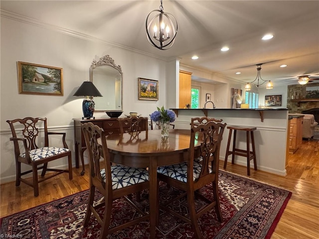 5017 Timbrook Ln, Winston-Salem, NC 27103 - dining area featuring a chandelier, ornamental molding, recessed lighting, and light wood-type flooring