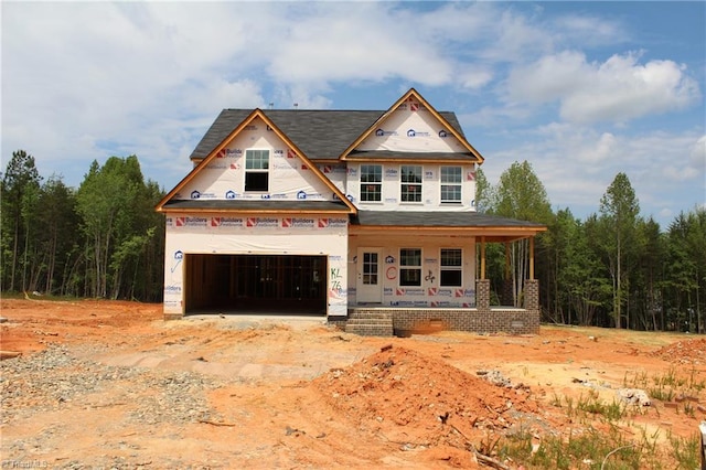 property in mid-construction featuring a porch and a garage