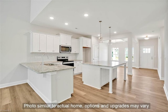 kitchen with stainless steel appliances, a sink, baseboards, white cabinetry, and recessed lighting