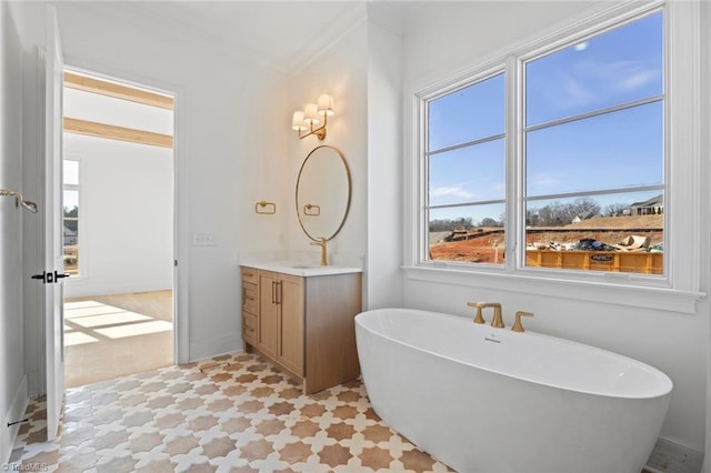 bathroom featuring vanity, ornamental molding, and a bath