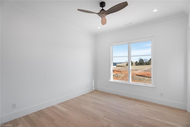 spare room with crown molding, ceiling fan, and light hardwood / wood-style floors