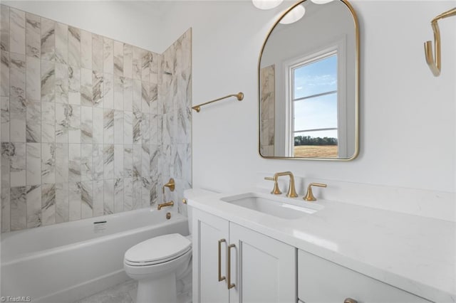 full bathroom featuring vanity, tiled shower / bath, and toilet