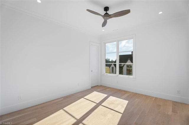 empty room featuring ceiling fan, ornamental molding, and light hardwood / wood-style floors