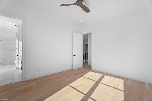 empty room with crown molding, ceiling fan, and wood-type flooring