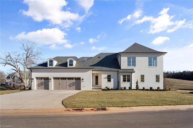 view of front of home featuring a front yard and a garage