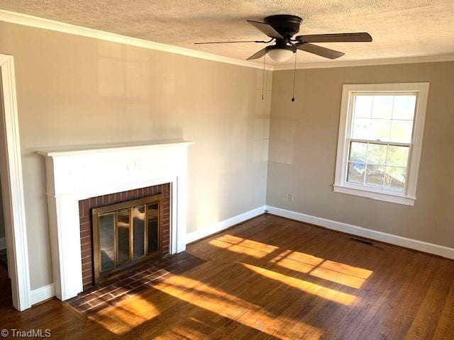 unfurnished living room featuring crown molding, a fireplace, dark wood-type flooring, and a textured ceiling