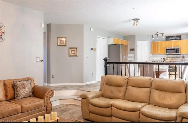5227 Eagle Creek Dr, Charlotte, NC 28269 - living area featuring light wood-style flooring, a textured ceiling, and baseboards