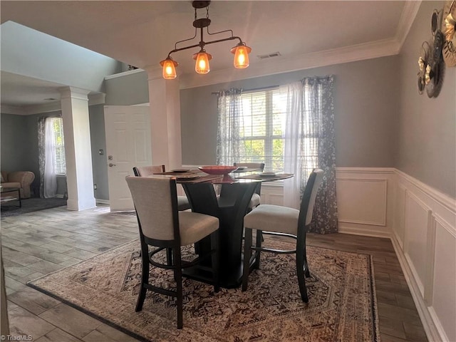 5227 Eagle Creek Dr, Charlotte, NC 28269 - dining room featuring wood finished floors, crown molding, a wainscoted wall, and a decorative wall