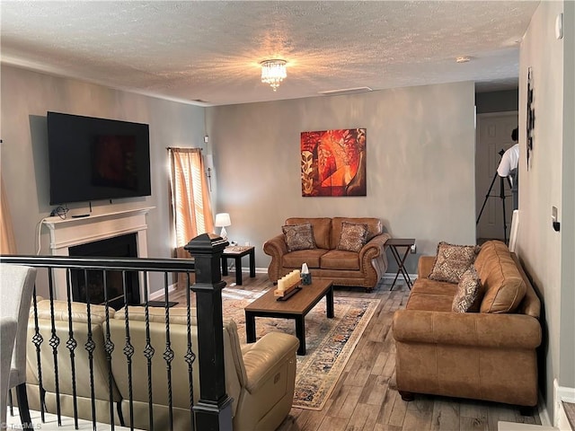 5227 Eagle Creek Dr, Charlotte, NC 28269 - living room with a textured ceiling, hardwood / wood-style flooring, a fireplace, and baseboards
