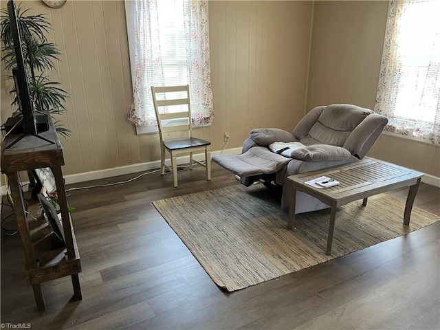 sitting room with dark wood-type flooring