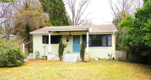 bungalow-style home with a front yard