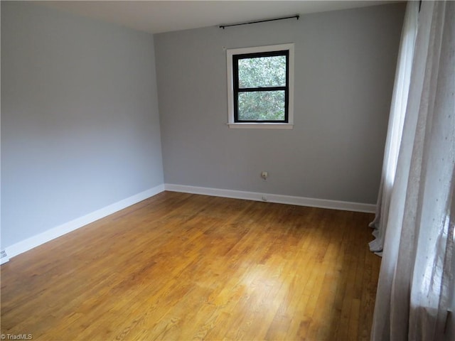 unfurnished room featuring wood-type flooring