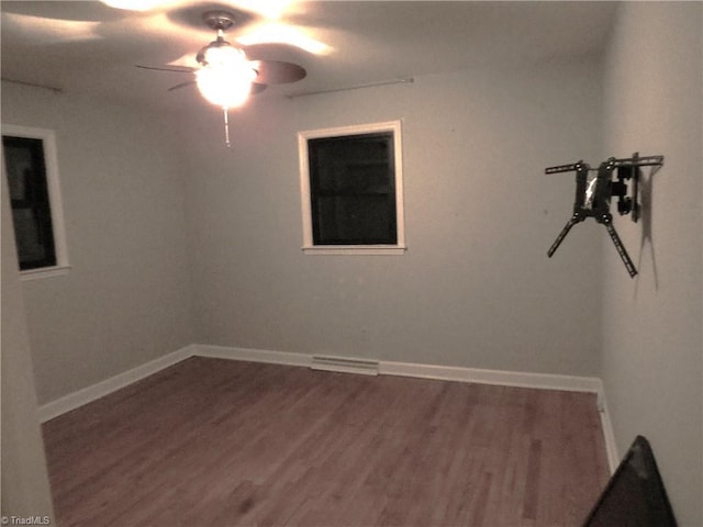 empty room with ceiling fan and hardwood / wood-style floors