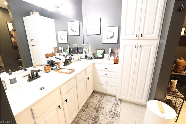 bathroom with tile patterned flooring and vanity