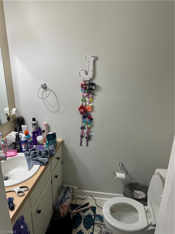 bathroom with tile patterned flooring, vanity, and toilet