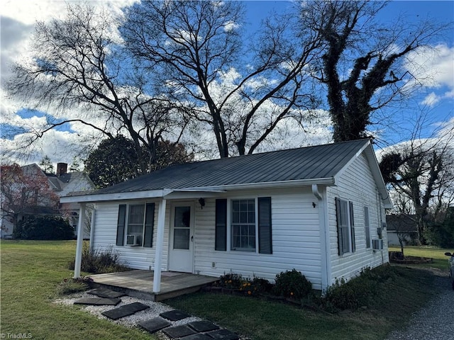 view of front facade with cooling unit and a front yard