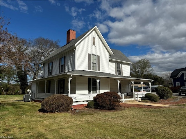 view of home's exterior featuring a porch, central air condition unit, and a yard