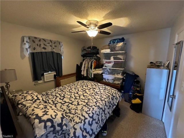 bedroom with carpet flooring, ceiling fan, and a textured ceiling