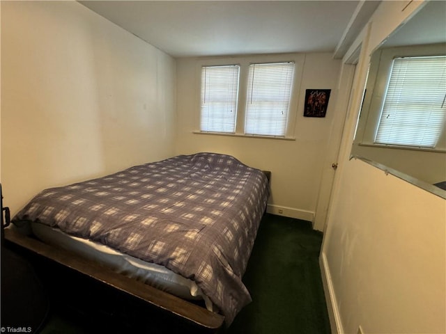 bedroom with dark colored carpet